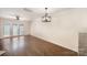 Bright living room with hardwood floors, chandelier, and access to the patio at 1218 Green Oaks Ln # E, Charlotte, NC 28205