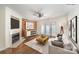 Cozy living room with a brick accent wall, fireplace, ceiling fan, and access to a patio at 1218 Green Oaks Ln # E, Charlotte, NC 28205