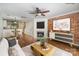 Inviting living room boasts a brick accent wall, fireplace, and seamless flow to the adjacent dining area at 1218 Green Oaks Ln # E, Charlotte, NC 28205