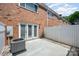 Back patio featuring brick wall, white fence, and air conditioner at 1218 Green Oaks Ln # E, Charlotte, NC 28205