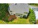 Aerial view of the home featuring a deck, manicured lawn, and mature trees at 12531 Morning Creek Ln, Charlotte, NC 28214