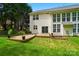 Backyard with wooden deck, beautiful landscaping, and exterior of the house at 12531 Morning Creek Ln, Charlotte, NC 28214