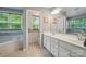 Bathroom with a double sink vanity, tile flooring, and natural light at 12531 Morning Creek Ln, Charlotte, NC 28214