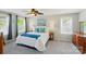 Bedroom with large windows, a ceiling fan, and decorative pillows and blanket at 12531 Morning Creek Ln, Charlotte, NC 28214