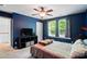 Comfortable bedroom featuring a ceiling fan, natural light and blue accent wall at 12531 Morning Creek Ln, Charlotte, NC 28214
