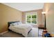 Neutral bedroom featuring a bed, side table, and window providing natural light at 12531 Morning Creek Ln, Charlotte, NC 28214