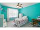 Bright bedroom with turquoise walls, floral curtains, and a cozy quilt at 12531 Morning Creek Ln, Charlotte, NC 28214