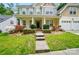 Attractive two-story home with a welcoming front porch and well-maintained landscaping at 12531 Morning Creek Ln, Charlotte, NC 28214