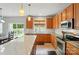 Well-lit kitchen with a quartz island and stainless steel appliances and bright cabinets at 12531 Morning Creek Ln, Charlotte, NC 28214