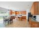 Open kitchen with an island, modern appliances, and casual dining area near backyard access at 12531 Morning Creek Ln, Charlotte, NC 28214