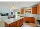 Well-lit kitchen features granite countertops, an island, wood cabinetry, and stainless steel appliances at 12531 Morning Creek Ln, Charlotte, NC 28214