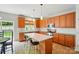 Bright kitchen featuring an island, modern appliances, and stylish pendant lighting at 12531 Morning Creek Ln, Charlotte, NC 28214