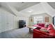 Cozy living room with red sectional sofa, TV, and ample natural light at 12531 Morning Creek Ln, Charlotte, NC 28214