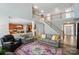 Inviting living room with open staircase, plush seating, and view into the adjacent kitchen at 12531 Morning Creek Ln, Charlotte, NC 28214