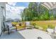 Relaxing backyard patio featuring comfortable seating, an umbrella, and a view of the grassy lawn at 127 Slip Shot Ln, Troutman, NC 28166