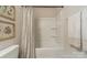 Clean bathroom showcasing a tub-shower combo with shower curtain and wall shelving for storage at 127 Slip Shot Ln, Troutman, NC 28166