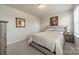 Bright bedroom with neutral color palette, framed artwork, and bedside tables with lamps at 127 Slip Shot Ln, Troutman, NC 28166
