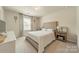 Airy bedroom featuring a tufted headboard, patterned curtains, and matching nightstands with decor at 127 Slip Shot Ln, Troutman, NC 28166