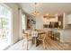 Charming breakfast nook with round table, open shelving, and bright light from sliding glass door at 127 Slip Shot Ln, Troutman, NC 28166