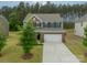 Charming two-story home with a brick facade, a two-car garage, and well-maintained landscaping at 127 Slip Shot Ln, Troutman, NC 28166