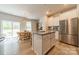 Bright and airy kitchen with an island, stainless steel refrigerator, and modern finishes at 127 Slip Shot Ln, Troutman, NC 28166