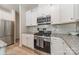 Modern kitchen featuring stainless steel appliances, granite countertops, and white cabinetry at 127 Slip Shot Ln, Troutman, NC 28166
