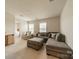 Spacious living room with a large sectional, ottoman, and open doorway to the laundry room at 127 Slip Shot Ln, Troutman, NC 28166
