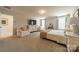 Spacious main bedroom with ample natural light, a dresser with a TV, and comfortable seating at 127 Slip Shot Ln, Troutman, NC 28166