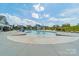 Community pool with water features and surrounding lounge chairs, nestled among neighborhood homes at 127 Slip Shot Ln, Troutman, NC 28166
