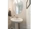 Stylish powder room featuring a pedestal sink, round mirror, and tasteful decor at 127 Slip Shot Ln, Troutman, NC 28166
