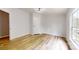 A spacious bedroom featuring wood floors, a ceiling fan, and a large window at 1274 Oakbrook Ln, Denver, NC 28037