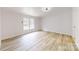 A spacious bedroom with wood floors, white walls, a ceiling fan, and lots of natural light at 1274 Oakbrook Ln, Denver, NC 28037