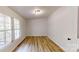 A sunny bedroom with wood floors and a large window at 1274 Oakbrook Ln, Denver, NC 28037