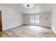 Spacious bedroom features wood floors, a ceiling fan, and a large window at 1274 Oakbrook Ln, Denver, NC 28037