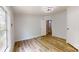 Bright bedroom features wood floors, a ceiling fan, and a large window at 1274 Oakbrook Ln, Denver, NC 28037