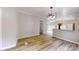 Well-lit dining room with modern light fixture and light colored wood flooring at 1274 Oakbrook Ln, Denver, NC 28037