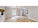 A bright dining room featuring wood floors, a modern light fixture, and large window at 1274 Oakbrook Ln, Denver, NC 28037