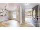 Bright entryway leading into the home with light colored wood flooring and views of the kitchen at 1274 Oakbrook Ln, Denver, NC 28037