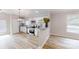 Well-lit kitchen with stainless steel appliances, granite countertops and light colored wood flooring at 1274 Oakbrook Ln, Denver, NC 28037
