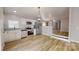 Modern kitchen featuring stainless steel appliances, granite countertops, and open layout to dining area at 1274 Oakbrook Ln, Denver, NC 28037