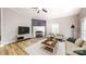 Cozy living room featuring a fireplace, hardwood floors, and ample natural light at 1274 Oakbrook Ln, Denver, NC 28037