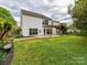 Expansive backyard with a well-maintained lawn, a patio, mature trees, and tasteful landscaping at 135 Coronilla Rd, Mooresville, NC 28117