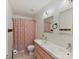 Bright bathroom featuring double sinks, a shower with a curtain, and neutral tile flooring at 135 Coronilla Rd, Mooresville, NC 28117