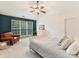 Bedroom featuring a blue accent wall, leather chair, and large window with natural light at 135 Coronilla Rd, Mooresville, NC 28117