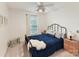 Cozy bedroom with blue bedding, wood nightstands, and large window allowing plenty of natural light at 135 Coronilla Rd, Mooresville, NC 28117
