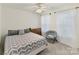 Inviting bedroom with large windows, gray chevron bedding, and cozy saucer chair at 135 Coronilla Rd, Mooresville, NC 28117
