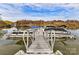 Community boat dock featuring multiple boat slips for easy lake access and enjoyment at 135 Coronilla Rd, Mooresville, NC 28117