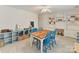 Bright bonus room features blue shelving, a wooden table and built-in white shelving, perfect for a playroom or home office at 135 Coronilla Rd, Mooresville, NC 28117
