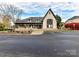 Community clubhouse with stone accents, a covered porch, and ample parking at 135 Coronilla Rd, Mooresville, NC 28117