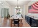Bright dining room with wood table, chandelier lighting, and view to the front yard at 135 Coronilla Rd, Mooresville, NC 28117